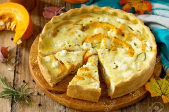 Classic Quiche Lorraine Pie with Pumpkin and Feta Cheese on a wo