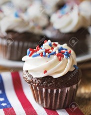 124522306-close-up-of-mini-cupcake-decorated-with-red-white-and-blue-sprinkles-on-a-minature-us-flag-additiona.jpg