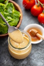 Homemade honey mustard sauce in a glass jar