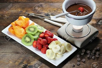51173192-chocolate-fondue-with-fruits-assortment-on-wooden-background.jpg