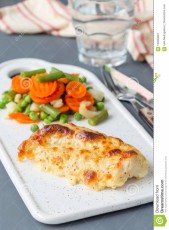 baked-cod-fish-fillet-under-cheese-mustard-pepper-cream-cr-crust-served-steamed-vegetables-ceramic-board-vertical-123849081.jpg