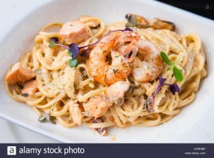 creamy-seafood-pasta-with-salmon-shrimp-mussels-and-grana-padano-cheese-KH5HBP.jpg