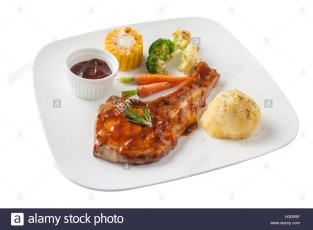 front-side-view-of-modern-style-pork-chop-with-barbecue-sauce-mashed-H30R9F.jpg