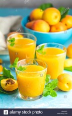 glass-of-fresh-healthy-apricot-or-peach-smoothie-or-juice-on-light-blue-concrete-surface-table-sunny-light-shallow-depth-of-the-field-close-up-cop-WJKHKT.jpg