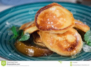 pancakes-caramelized-pear-tea-lemon-mint-selective-focus-wooden-white-background-top-view-pancakes-112425825-1.jpg