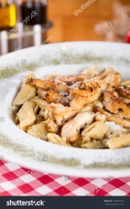stock-photo-delicious-sliced-grilled-chicken-tomato-parmesan-cheese-and-creamy-herbed-sauce-over-penne-pasta-766383124.jpg