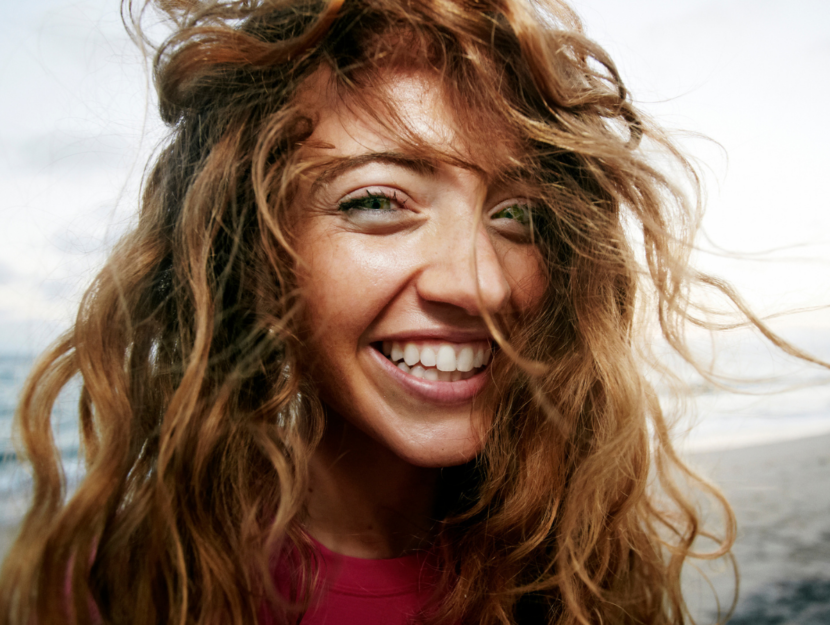 girl with wavy hair at the sea